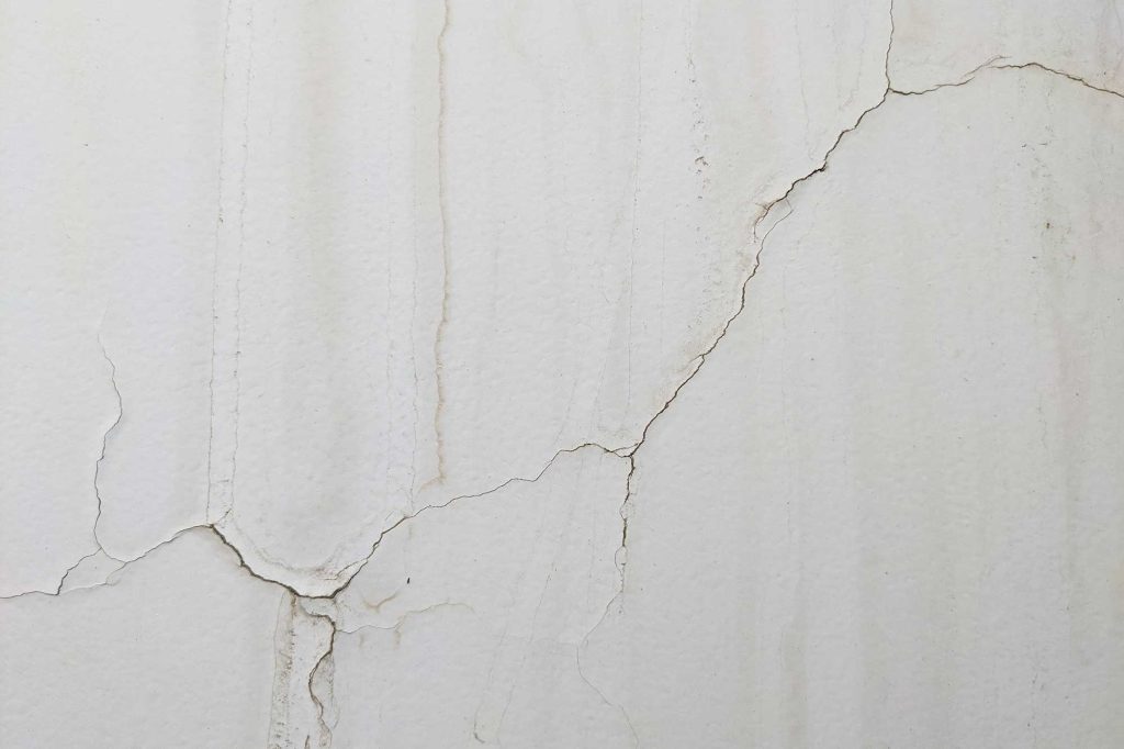 A close-up image of a cracked drywall panel needing professional repair