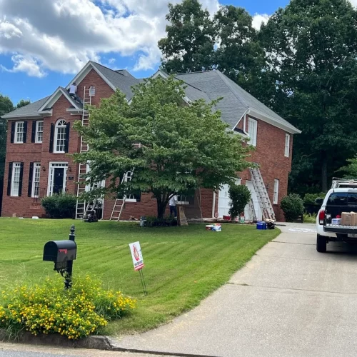 servicing a red brick house renovation with ovipainting service truck